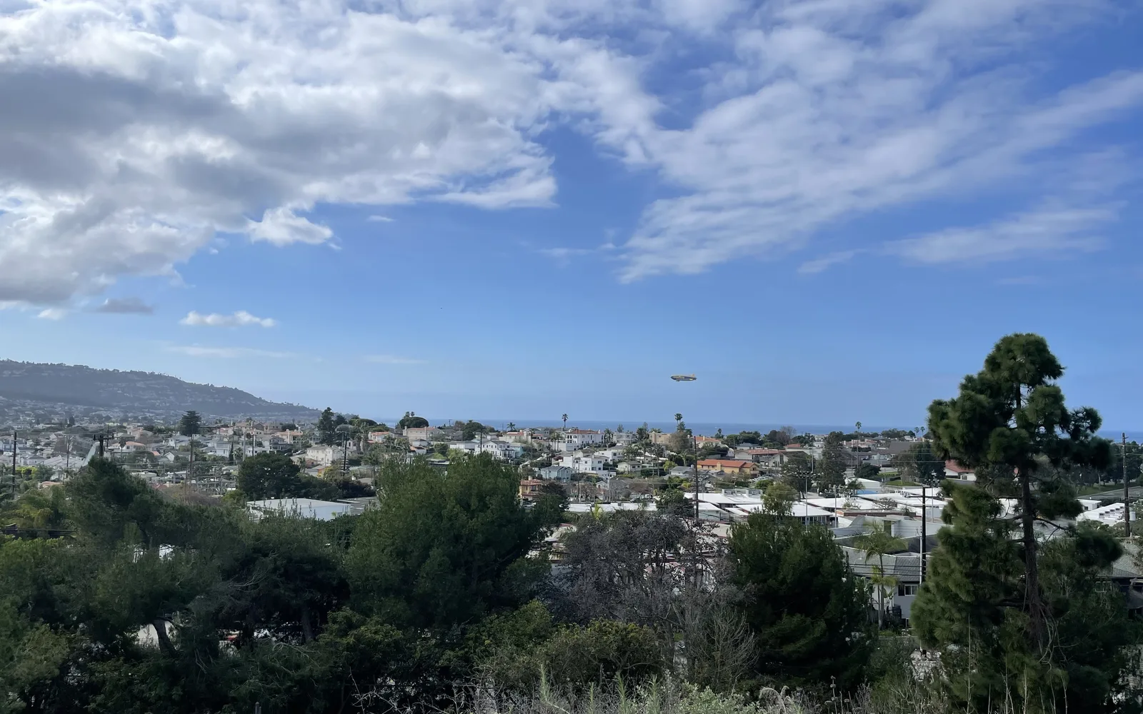 Aerial view of Goodyear Blimp flying low over Torrance and Redondo Beach in the South Bay area of Los Angeles County