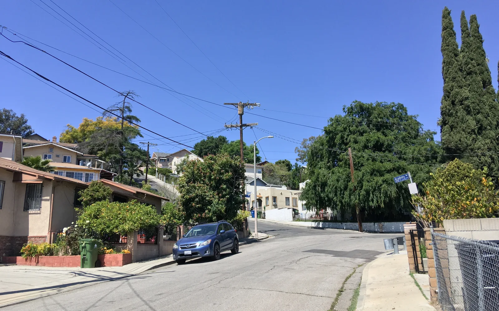 Residential neighborhood street in the Baird Park area of Los Angeles with houses, trees, and green lawns